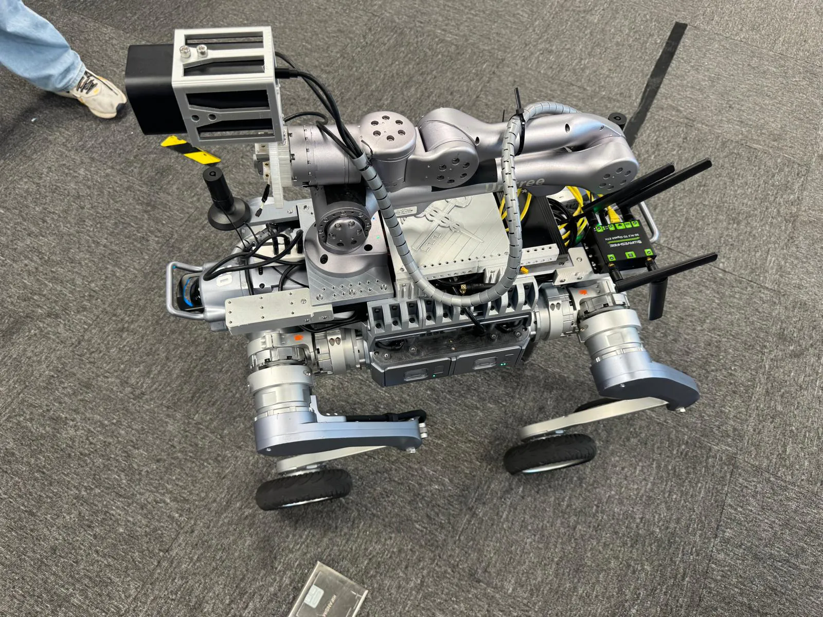 A wheeled robot platform with two manipulator arms, on the floor of the System Integration Lab